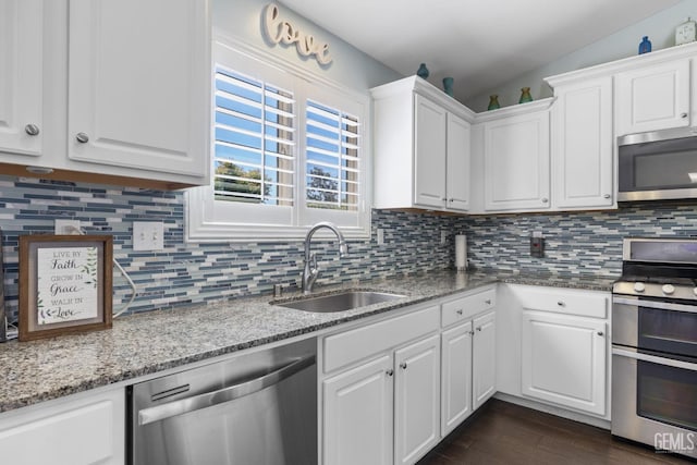 kitchen featuring a sink, white cabinetry, appliances with stainless steel finishes, and dark wood finished floors
