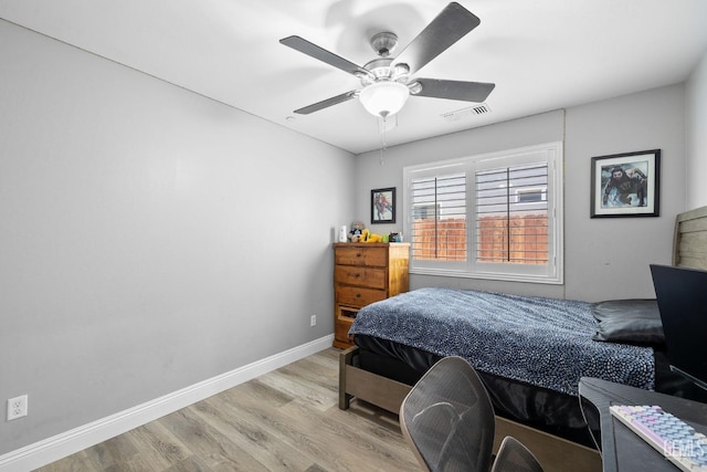 bedroom with a ceiling fan, baseboards, visible vents, and light wood-style flooring