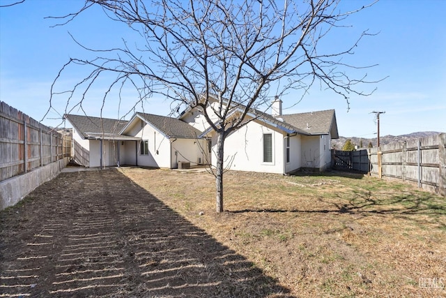 view of side of home with stucco siding and a chimney