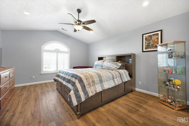 bedroom featuring lofted ceiling, wood finished floors, baseboards, a ceiling fan, and recessed lighting