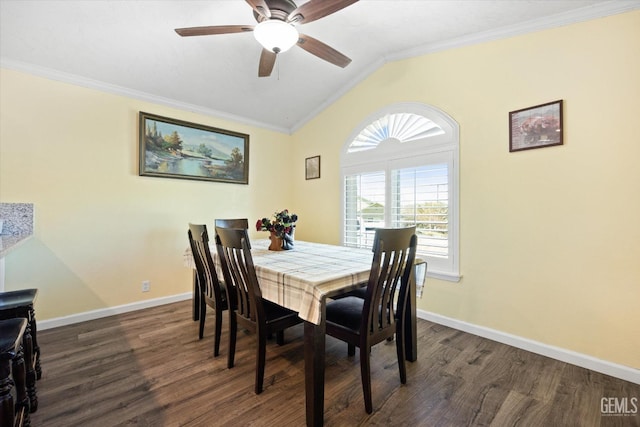 dining room with vaulted ceiling, crown molding, wood finished floors, baseboards, and ceiling fan