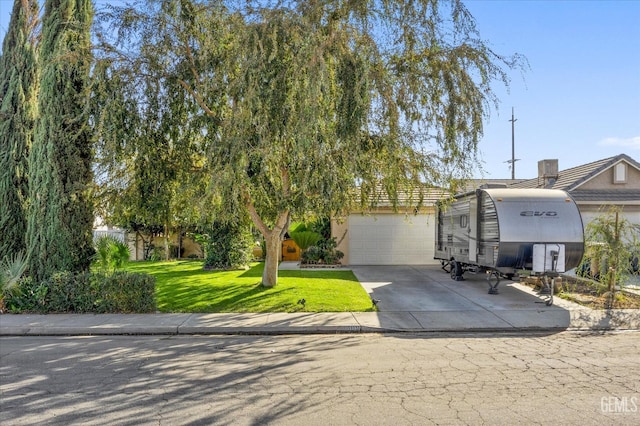 view of front facade with a garage and a front lawn