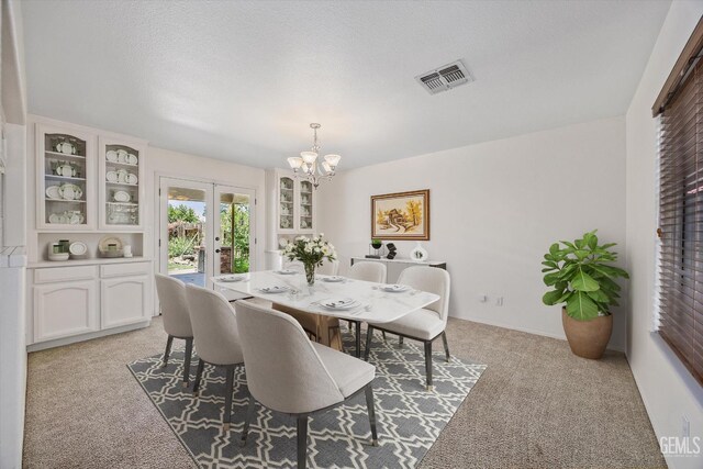 7310 Clifftop Way, Bakersfield, CA 93306 - dining room with light carpet, a chandelier, and french doors
