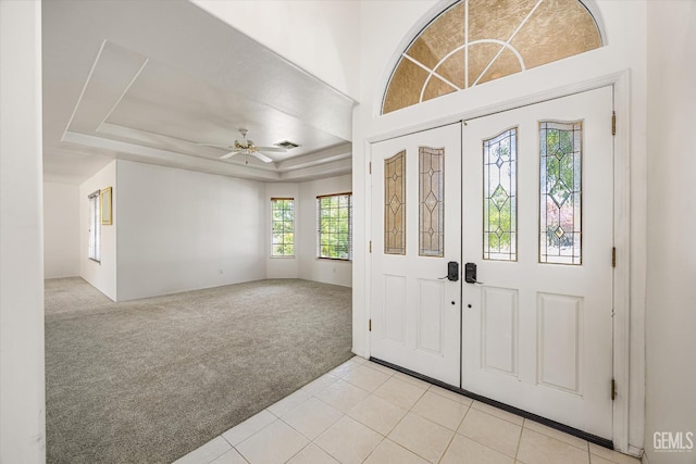 7310 Clifftop Way, Bakersfield, CA 93306 - foyer with light colored carpet, ceiling fan, light tile patterned flooring, and a raised ceiling