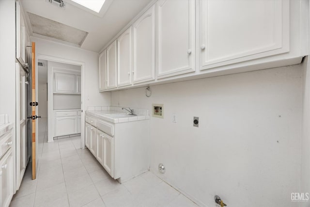 7310 Clifftop Way, Bakersfield, CA 93306 - laundry area featuring hookup for a gas dryer, washer hookup, cabinet space, electric dryer hookup, and light tile patterned floors