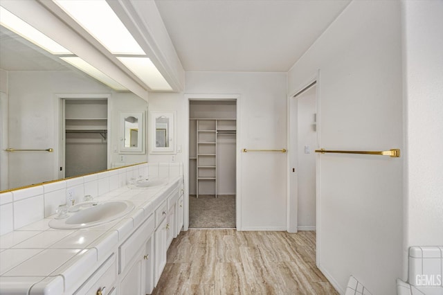 7310 Clifftop Way, Bakersfield, CA 93306 - full bath featuring double vanity, a walk in closet, and wood finished floors