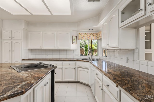 7310 Clifftop Way, Bakersfield, CA 93306 - kitchen featuring stove, white cabinets, dark stone counters, light tile patterned floors, and decorative backsplash
