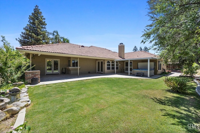 7310 Clifftop Way, Bakersfield, CA 93306 - back of property featuring a hot tub, a tile roof, a patio, french doors, and a chimney