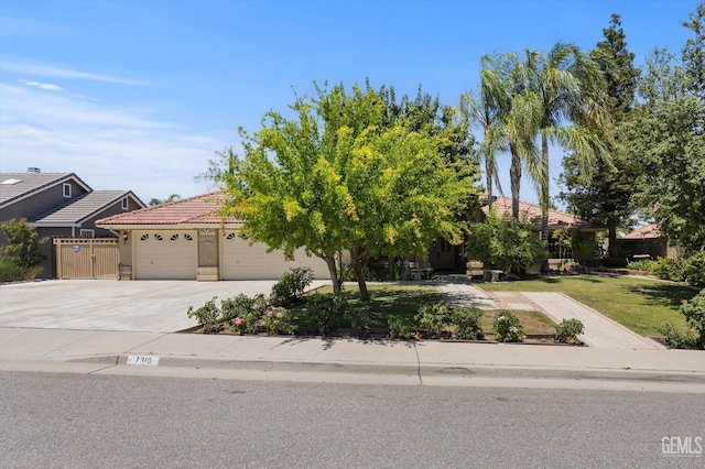 7310 Clifftop Way, Bakersfield, CA 93306 - view of front of house featuring driveway, an attached garage, a tiled roof, and stucco siding