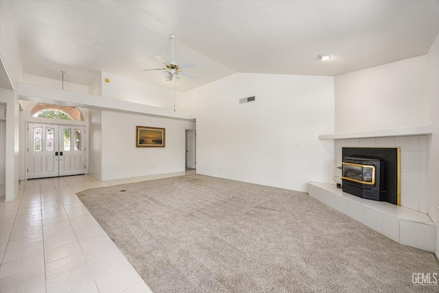 7310 Clifftop Way, Bakersfield, CA 93306 - unfurnished living room with ceiling fan, a wood stove, vaulted ceiling, light tile patterned floors, and french doors
