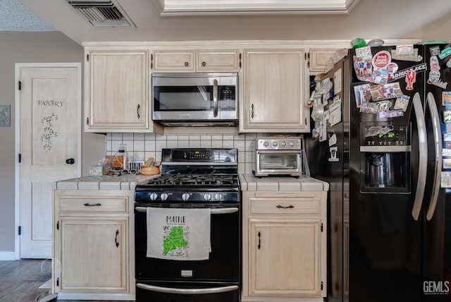 510 Sierra St, Taft, CA 93268 - kitchen with black appliances, tile countertops, and light brown cabinets