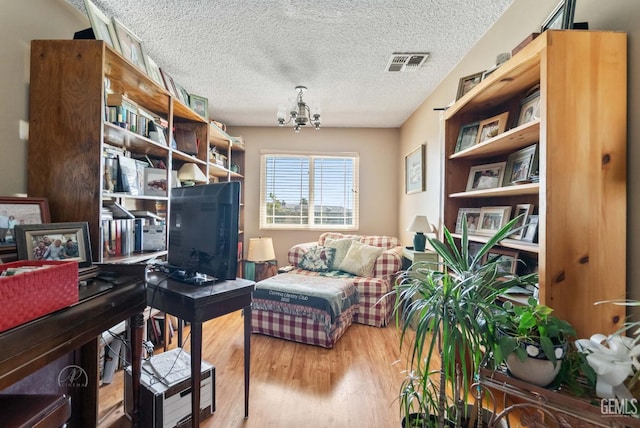 510 Sierra St, Taft, CA 93268 - office featuring a chandelier, wood finished floors, and a textured ceiling