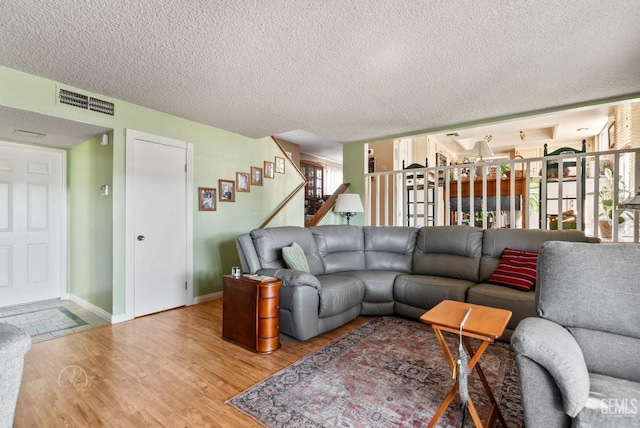 510 Sierra St, Taft, CA 93268 - living area featuring light wood-style flooring, stairs, and a textured ceiling