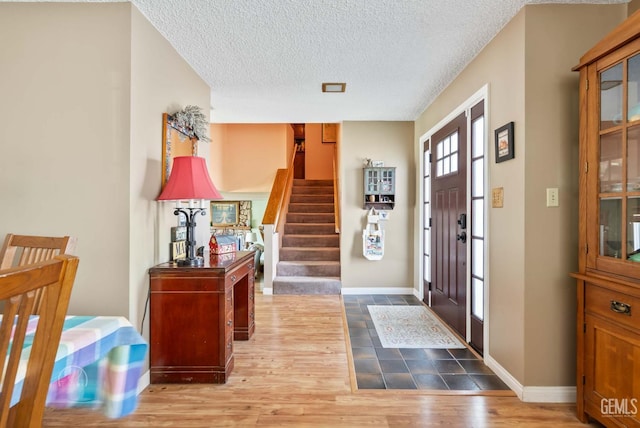 510 Sierra St, Taft, CA 93268 - foyer entrance with wood finished floors, a textured ceiling, and stairs