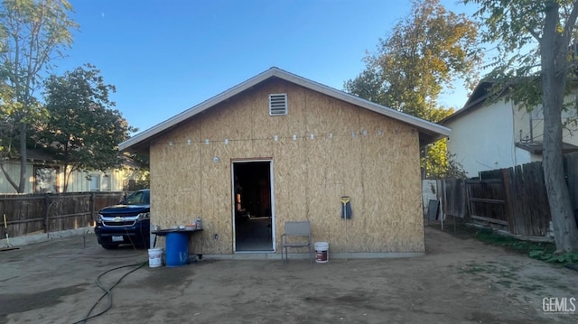 rear view of property with an outbuilding