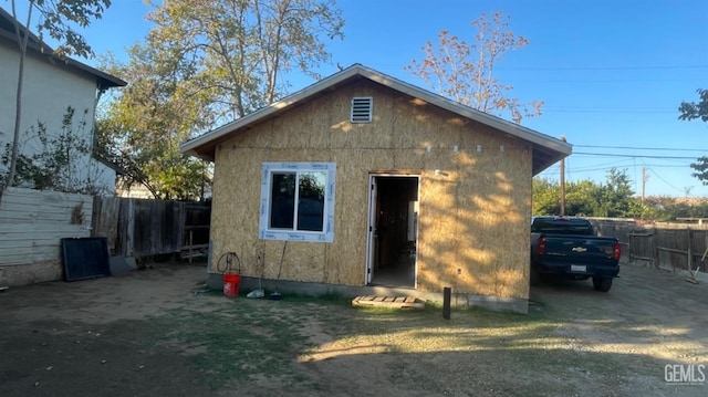 rear view of property with an outbuilding