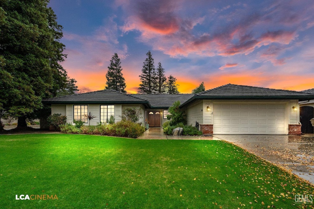 view of front of property featuring a lawn and a garage