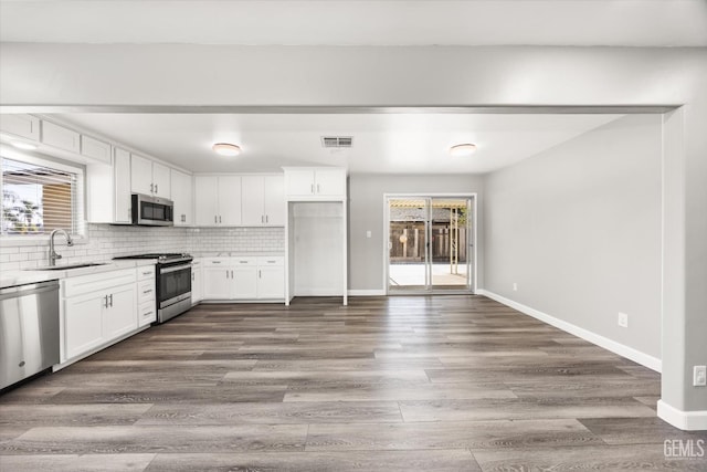 kitchen featuring a sink, visible vents, white cabinetry, light countertops, and appliances with stainless steel finishes