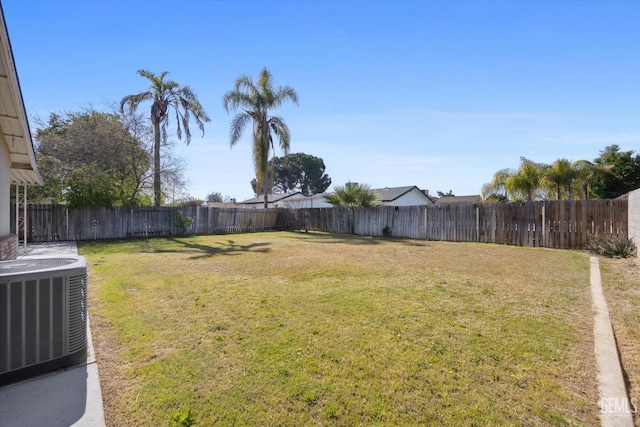 view of yard with a fenced backyard and central AC