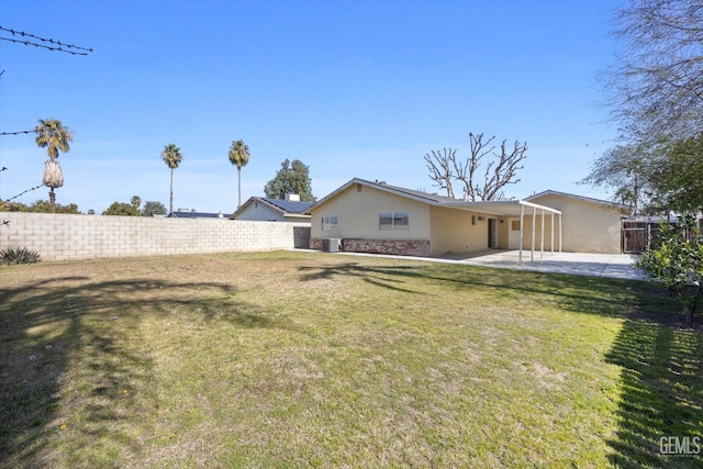 view of yard with a patio area, a fenced backyard, and central AC