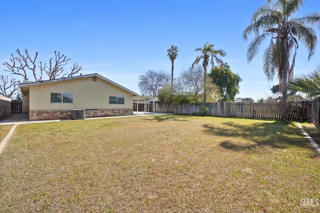 view of yard featuring a fenced backyard and central AC unit