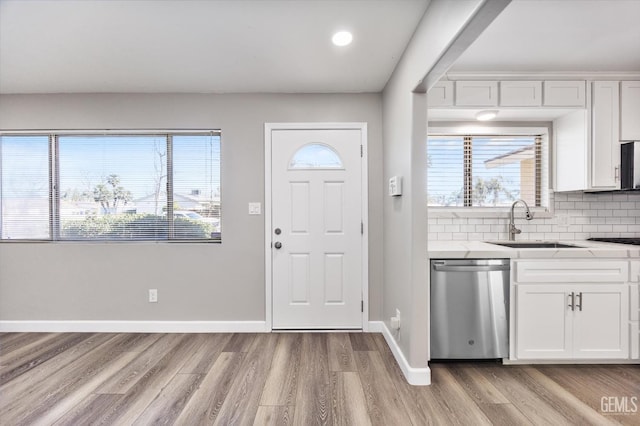 foyer with light wood finished floors and baseboards