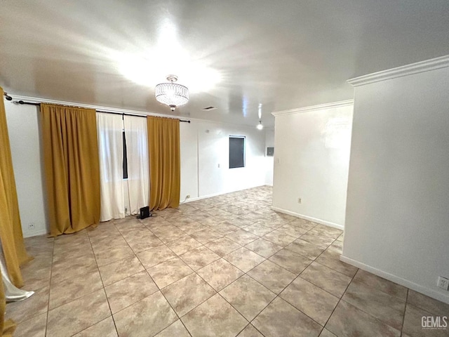 unfurnished room featuring a notable chandelier, light tile patterned floors, and ornamental molding