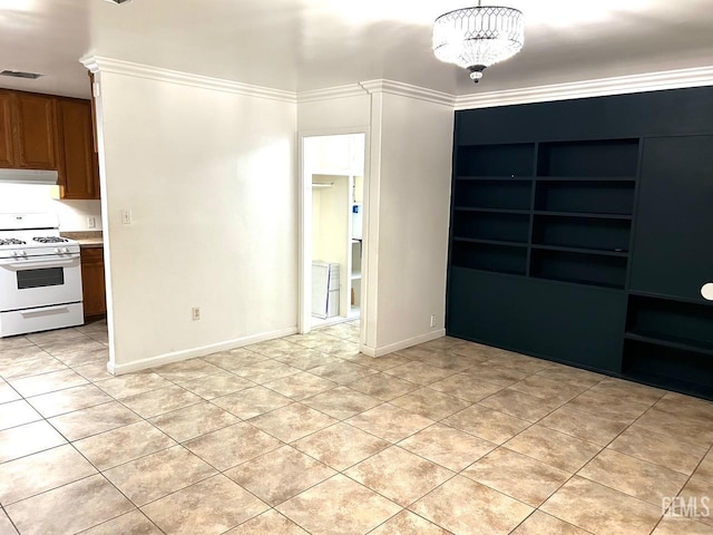 unfurnished room with ornamental molding, a notable chandelier, and light tile patterned flooring