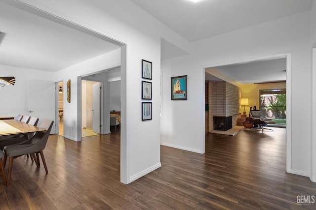 2513 Elm St, Bakersfield, CA 93301 - dining room with wood finished floors, baseboards, and a brick fireplace