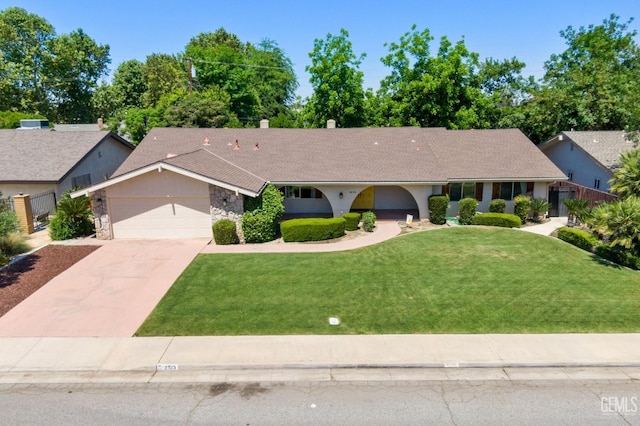 2513 Elm St, Bakersfield, CA 93301 - single story home with a garage, driveway, a front lawn, stone siding, and a chimney