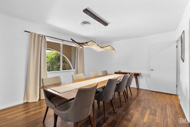 2513 Elm St, Bakersfield, CA 93301 - dining space with dark wood-style flooring and baseboards