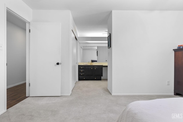 2513 Elm St, Bakersfield, CA 93301 - bedroom with light carpet, baseboards, and ensuite bath
