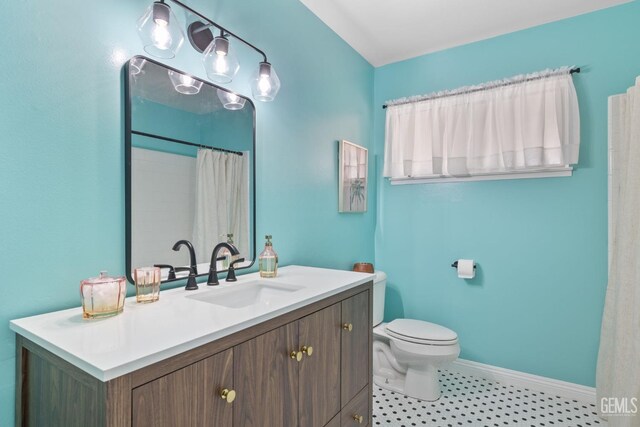 2513 Elm St, Bakersfield, CA 93301 - bathroom with toilet, baseboards, and vanity