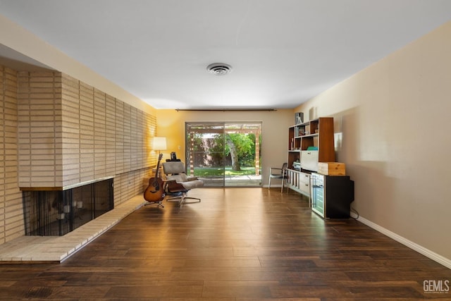 2513 Elm St, Bakersfield, CA 93301 - living area with wood finished floors, a fireplace, and baseboards