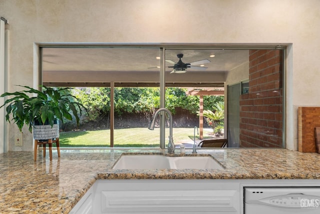 2513 Elm St, Bakersfield, CA 93301 - kitchen with a sink, ceiling fan, white dishwasher, white cabinetry, and light stone countertops