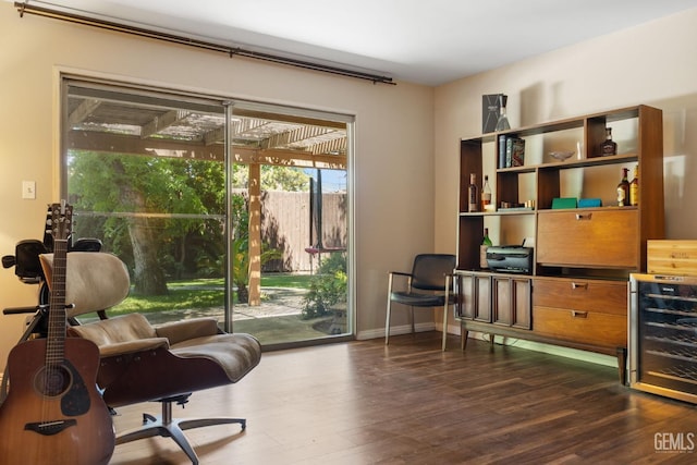 2513 Elm St, Bakersfield, CA 93301 - living area featuring dark wood finished floors, a desk, beverage cooler, and baseboards