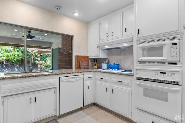 2513 Elm St, Bakersfield, CA 93301 - kitchen featuring white appliances, under cabinet range hood, a sink, white cabinetry, and decorative backsplash