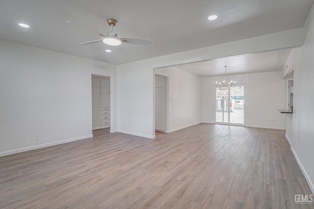 1201 Quincy St, Delano, CA 93215 - spare room with a chandelier, a ceiling fan, light wood-style flooring, baseboards, and recessed lighting