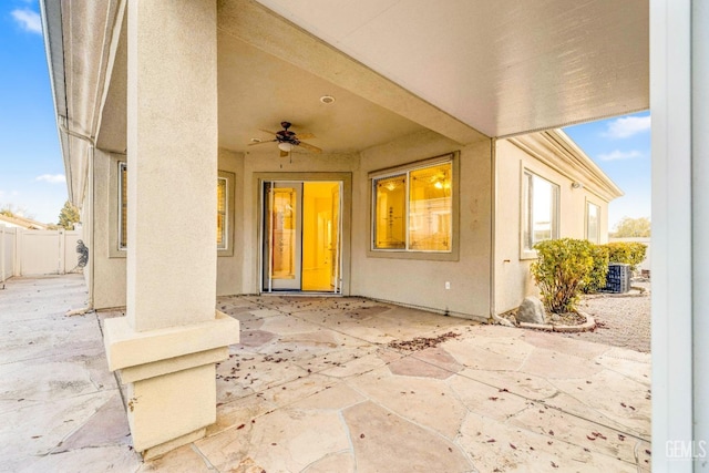 view of patio with central air condition unit, ceiling fan, and fence