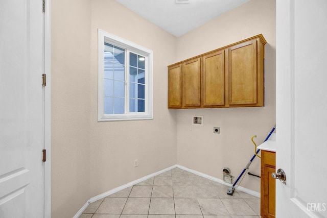 laundry room featuring hookup for an electric dryer, light tile patterned floors, hookup for a washing machine, baseboards, and cabinet space