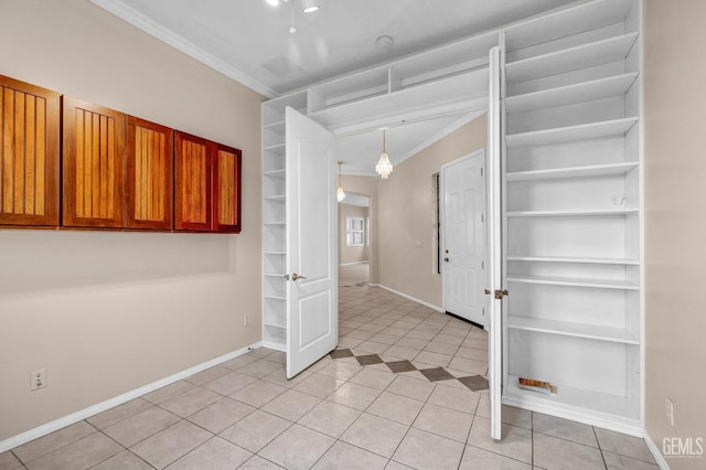 foyer featuring baseboards, ornamental molding, and light tile patterned floors