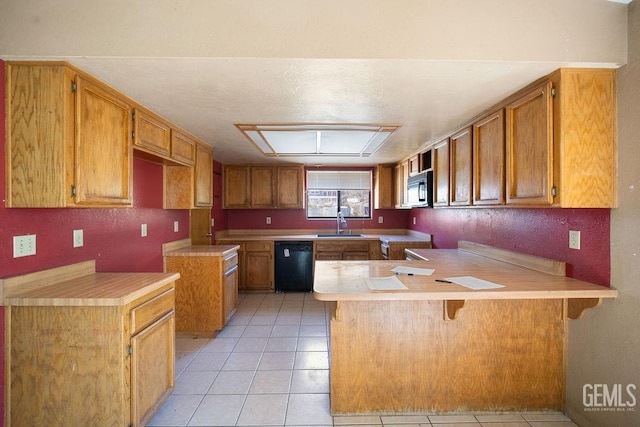 4120 Willow Trl, Frazier Park, CA 93225 - kitchen featuring black appliances, a peninsula, brown cabinets, light tile patterned floors, and light countertops