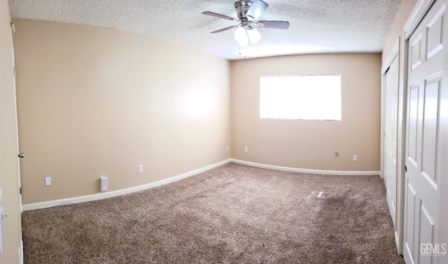 unfurnished bedroom featuring a textured ceiling, carpet floors, and ceiling fan