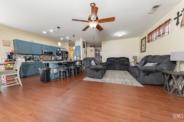 living room featuring ceiling fan and light hardwood / wood-style flooring