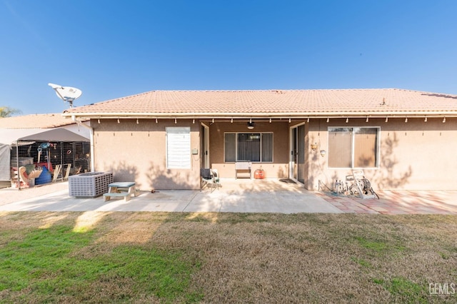 back of property with a patio area, cooling unit, a yard, and ceiling fan