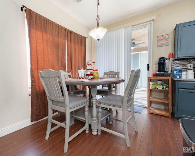 dining room with ceiling fan and dark hardwood / wood-style flooring