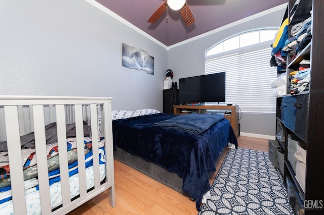 bedroom featuring ceiling fan, ornamental molding, and hardwood / wood-style flooring