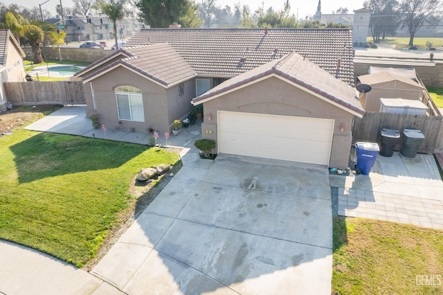 single story home featuring a garage and a front yard