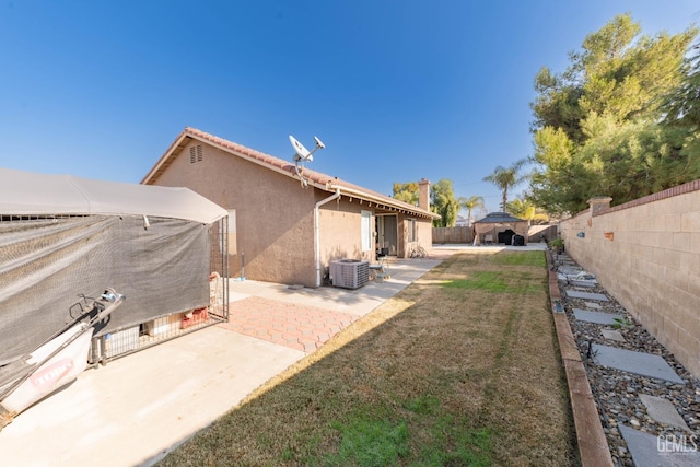 view of yard featuring central AC and a patio