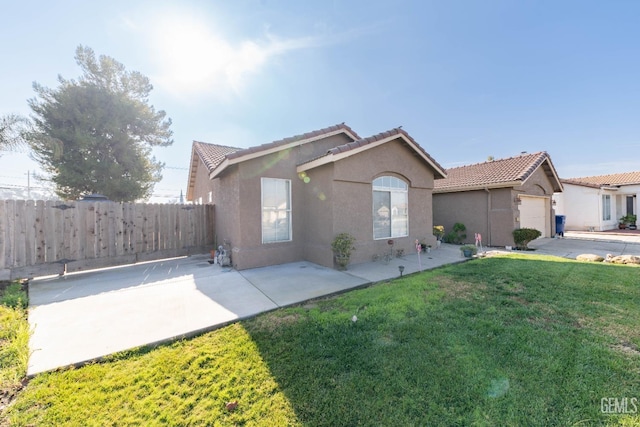 ranch-style house with a front lawn and a patio